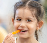 child eating carrot
